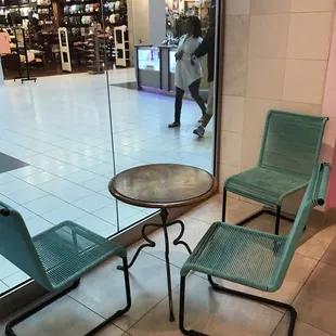 two chairs and a table in a mall