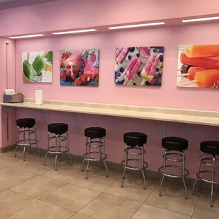 a row of stools in front of a counter