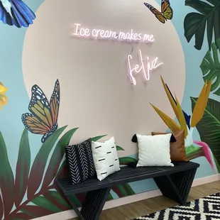 a bench in front of a mural