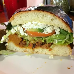 a sandwich with lettuce, tomato, and cheese