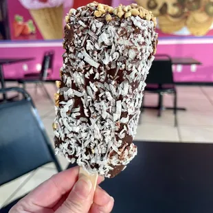 Coconut ice cream, dipped in chocolate, nuts opposite side. 6/9/22
