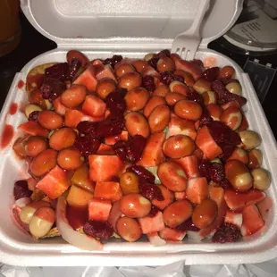 a container of strawberries and cherries