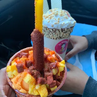 a person holding a bowl of fruit