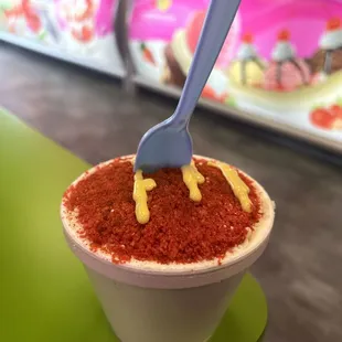 a cup of ice cream with a spoon sticking out of it