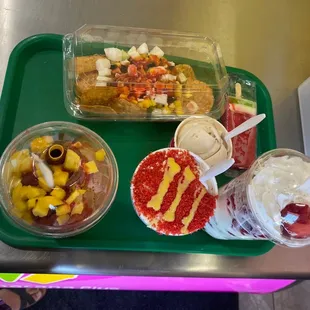 ows a tray of fruit and ice cream