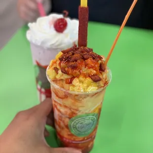 a hand holding a cup of ice cream