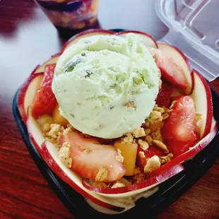 a bowl of fruit and ice cream