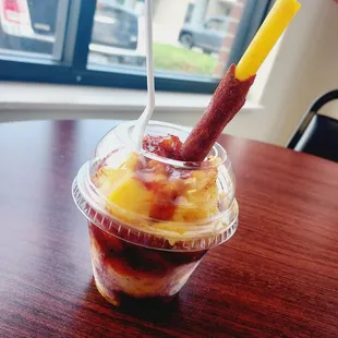 a fruit smoothie in a plastic cup