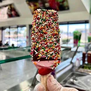 an ice cream cone covered in sprinkles