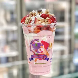 a cup of ice cream and strawberries