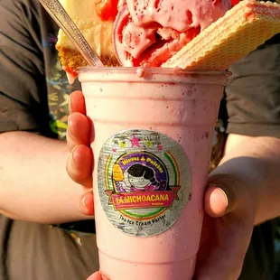 a woman holding a cup of ice cream