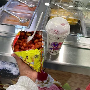 a hand holding a bag of beans