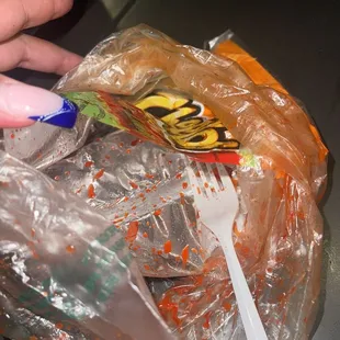 a hand holding a bag of chips