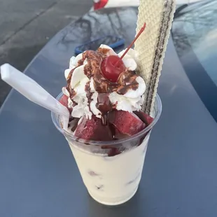 an ice cream sundae with strawberries and whipped cream