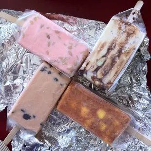 From bottom left clockwise: rum raisin, pink pinenuts, coffee almond, and mango sweet chili