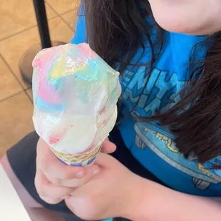 Cone with strawberries and cream and bubblegum (I think) scoops