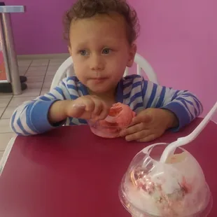 a little boy eating ice cream
