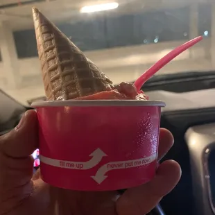 a hand holding an ice cream cone