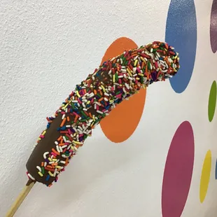 Frozen banana dipped in chocolate with sprinkles