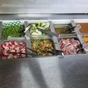 Salsa bar. The red onions are mixed with sliced Habaneros! Delicious!