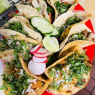 a plate of tacos with a lime wedge