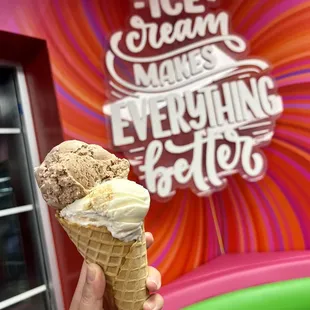 a hand holding an ice cream cone
