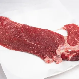 a piece of beef on a white plate