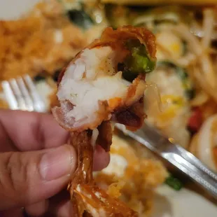 a person holding a piece of food