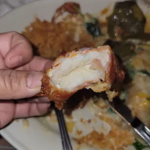 a person holding a piece of food