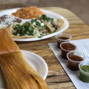3 tacos, rice, beans, and a  piña cucumber drink plus a chicken tamale and flan for desert.