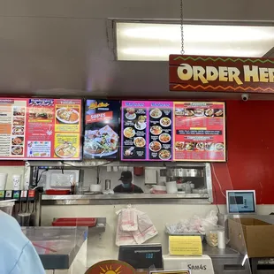 a man standing in front of a menu