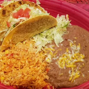 Crispy beef tacos with rice and beans.