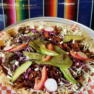 Come try our Oaxacan Supreme Pizza (Tlayuda) loaded with fresh vegetables, cheeses, meats and topped off with our famous Chapulines.