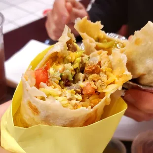 a person holding a burrito