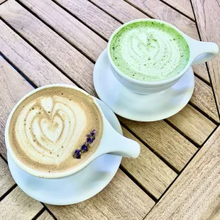 two cups of coffee on a wooden table