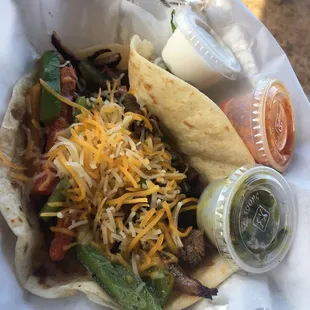 Steak fajita taco with salsas and sour cream