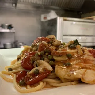 a plate of pasta with chicken and vegetables