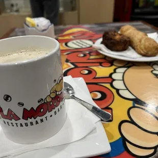 a cup of coffee and a plate of croissants