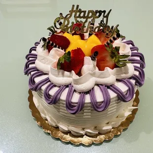 a birthday cake with strawberries on top