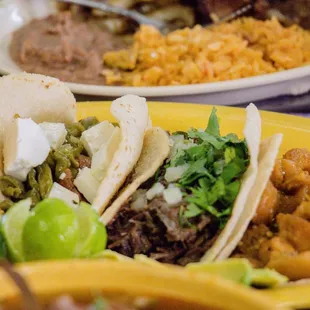 Variety of tacos with homedame mexican food every day where you can choose diferent dishes.