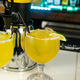 two margaritas on a bar