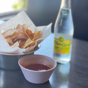 a bowl of chips and a bottle of water