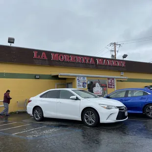 two cars parked in front of the store