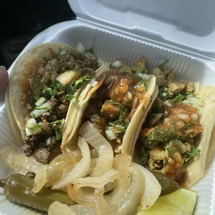 two tacos in a styrofoam container