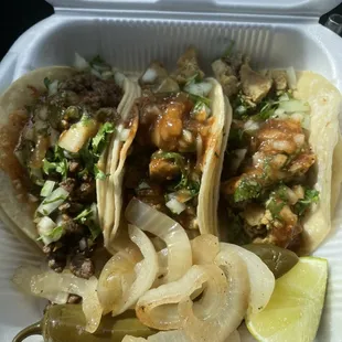 two tacos in a styrofoam container