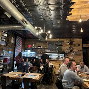 people sitting at tables in a restaurant