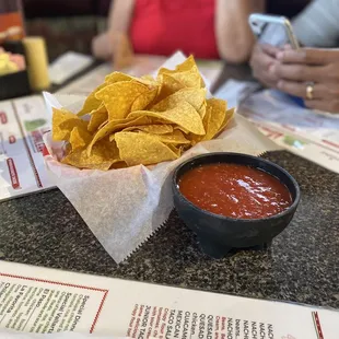 a bowl of chips and a bowl of salsa