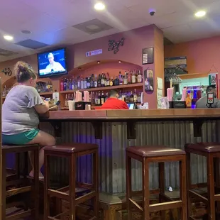 a woman sitting at the bar