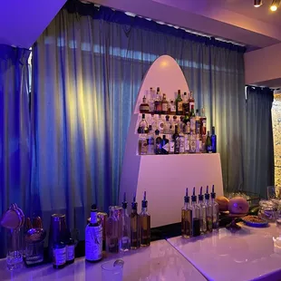 a bar with bottles of alcohol