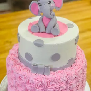 a baby elephant on top of a cake